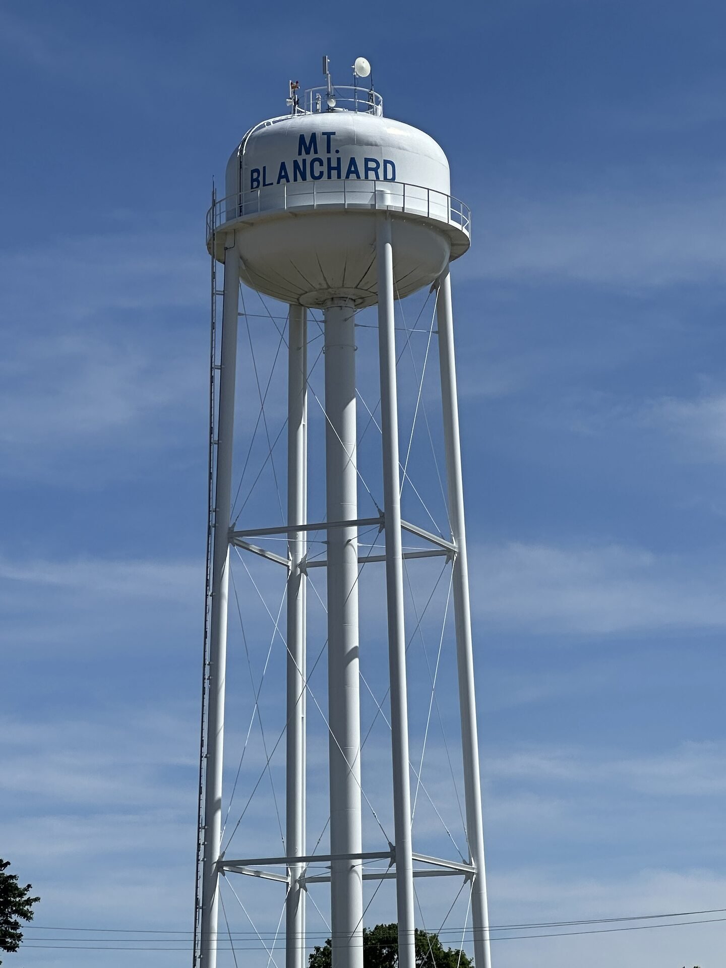 Mt. Blanchard water tower standing tall against a blue sky